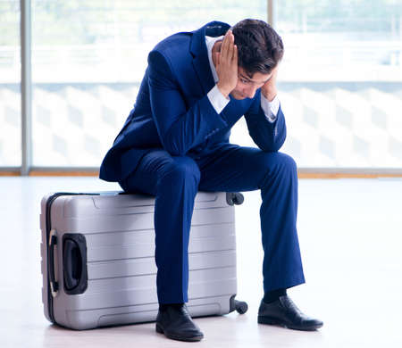 Businessman waiting for his flight at airportの写真素材