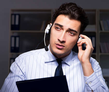 Call center operator talking to customer during night shift