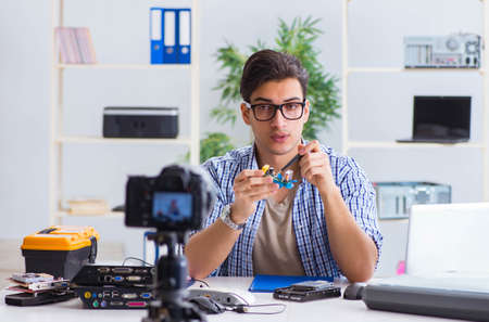 Vlogger recording computer repair on camera for vlog blogの写真素材