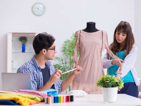 Pregnant woman visiting tailor for new clothingの写真素材