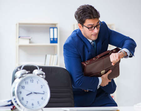Businessman in bad time management conceptの写真素材
