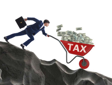 Businessman pushing wheelbarrow with tax moneyの写真素材