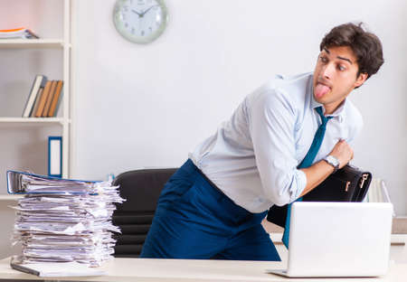 Overloaded busy employee with too much work and paperwork