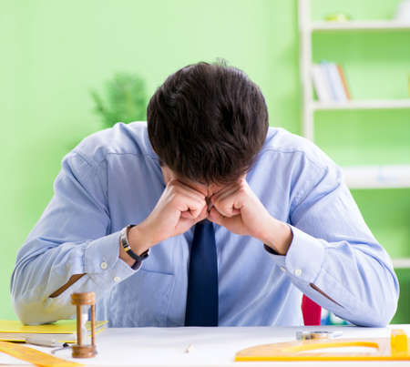 Young male architect working at the projectの写真素材