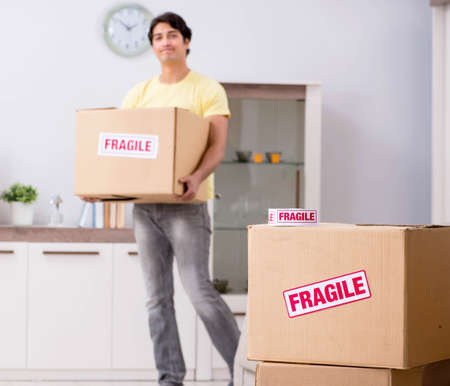 Man moving house and relocating with fragile items