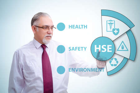 HSE concept with businessman pressing virtual buttonの写真素材