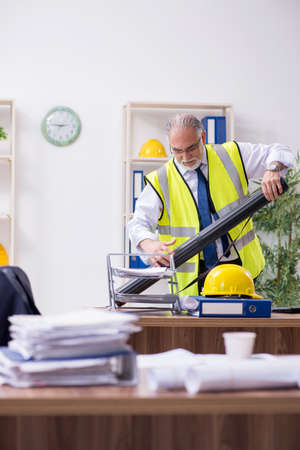 Old male architect working in the officeの写真素材