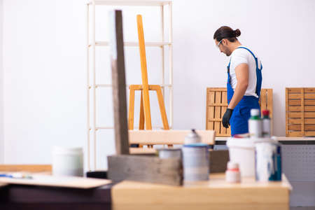 Young male contractor working in workshopの写真素材