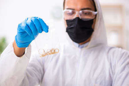 Male expert criminologist working in the lab for evidence