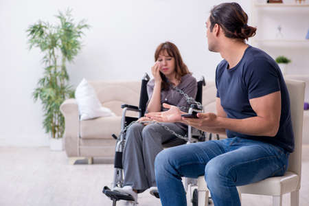 Disabled wife and young husband at homeの写真素材