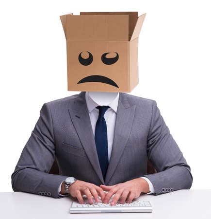 Businessman with box and unhappy faceの写真素材
