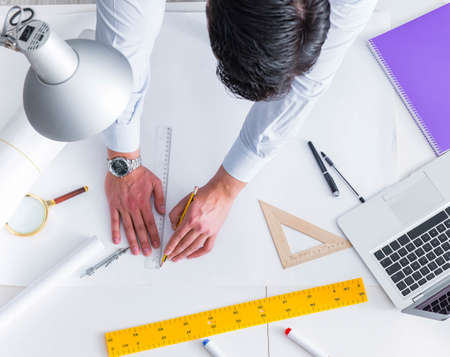 Engineer working on new project drawingsの写真素材