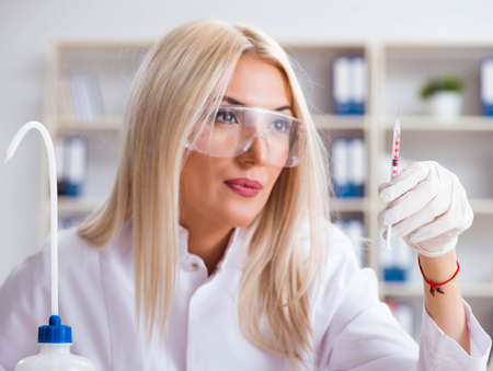 Young female woman doctor in hospital clinic labの写真素材