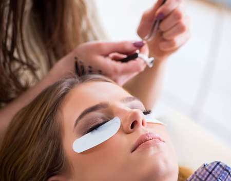 Young woman getting eyelash extensionの写真素材