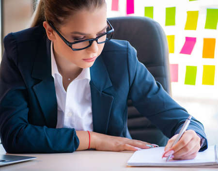 Beautiful female employee with many conflicting prioritiesの写真素材