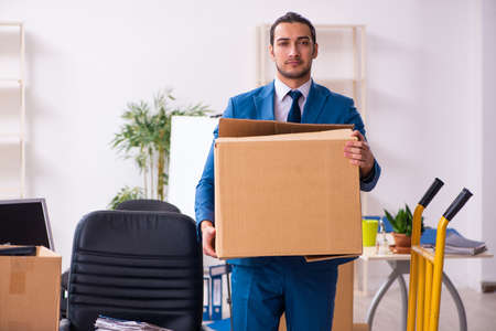 Young male employee in moving conceptの写真素材