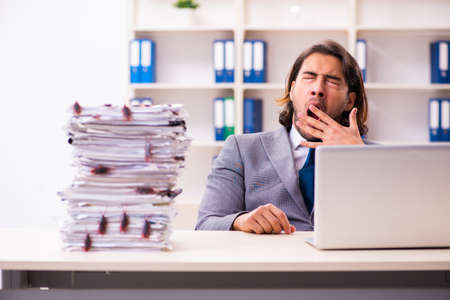 Young male employee and too many cockroaches in the officeの写真素材