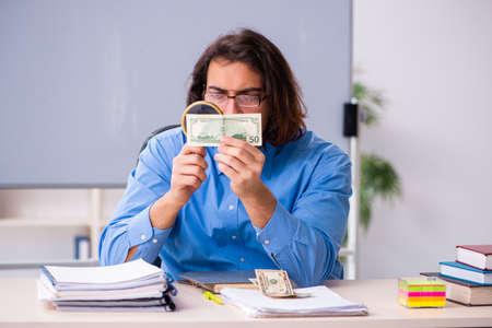 Young male teacher in the classroomの写真素材