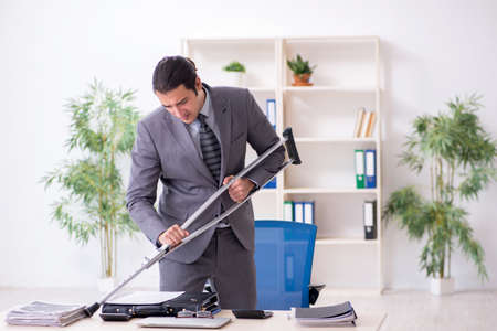 Young male employee after accident at workplaceの写真素材