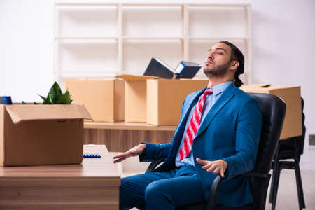 Young male employee in relocation conceptの写真素材