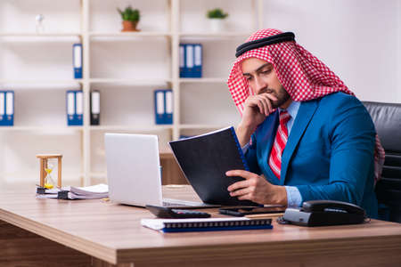 Young male arab employee working in officeの写真素材