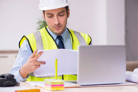Young male architect working in the office
