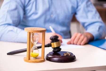 Young man in courthouse in divorcing conceptの写真素材