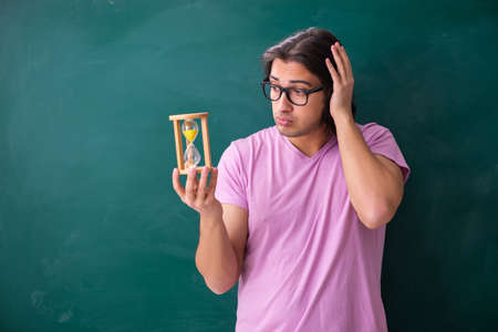 Young male student in front of board