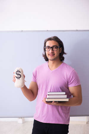 Young male student in front of boardの写真素材