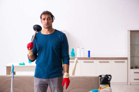 Young man husband doing plumbing at homeの写真素材