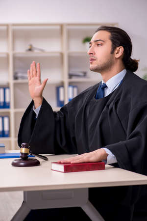 Young male judge working in courthouseの写真素材