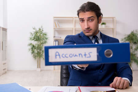 Young male financial manager in the officeの写真素材