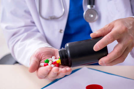 Old male doctor therapist working in the clinicの写真素材