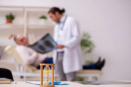 Male patient visiting doctor radiologist in time management concの写真素材