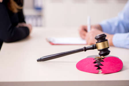 Young pair in courthouse in divorcing conceptの写真素材