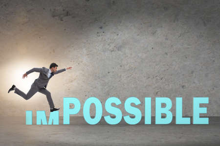 Businessman in impossible business conceptの写真素材