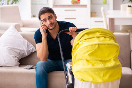 Young father looking after newbornの写真素材