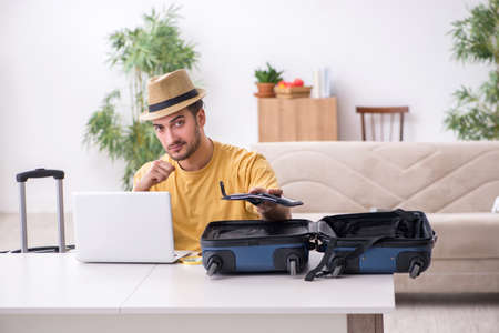 Young man preparing for journey at homeの写真素材