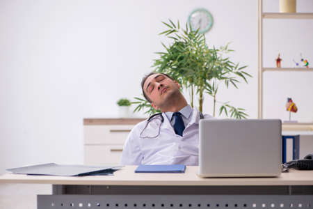 Young male doctor working in the clinicの写真素材