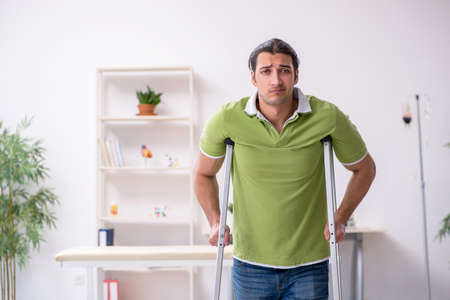 Young man waiting for doctor in the clinicの写真素材