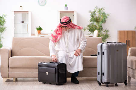 Old arab businessman preparing for business tripの写真素材
