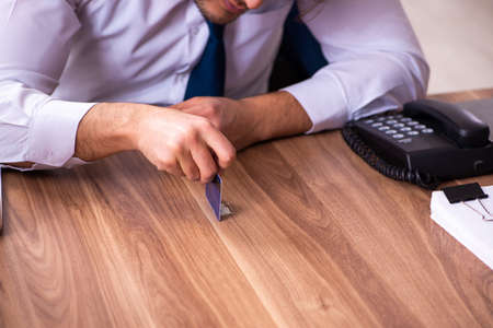 Drug addicted male employee working in the officeの写真素材