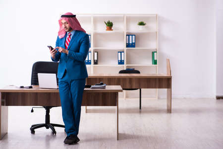 Young male arab employee working in officeの写真素材