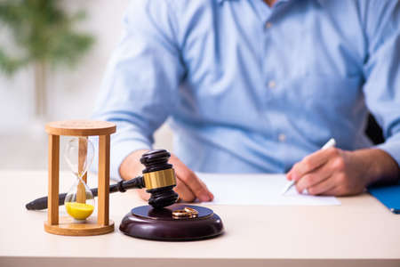 Young man in courthouse in divorcing concept