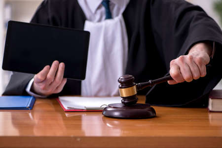 Old male judge working in courthouse