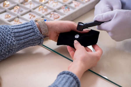 Male jeweler and female client at storeの写真素材