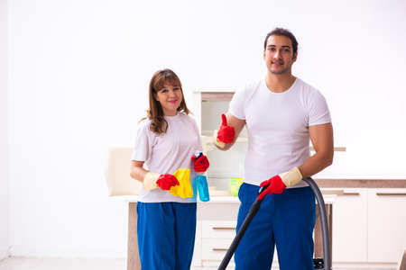 Young pair doing housework at homeの写真素材