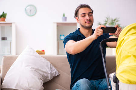 Young father looking after newbornの写真素材