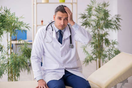 Young male doctor working in the clinicの写真素材