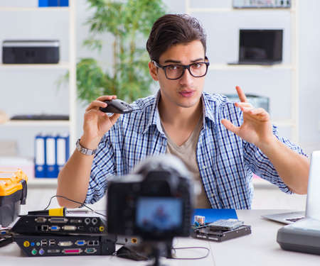 Vlogger recording computer repair on camera for vlog blog